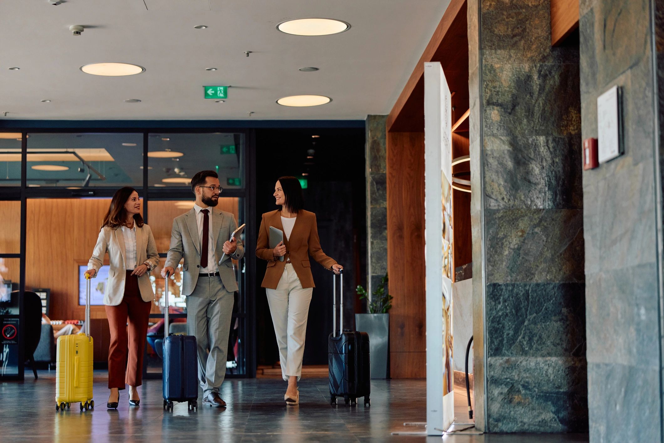 Business colleagues arriving at hotel for corporate trip